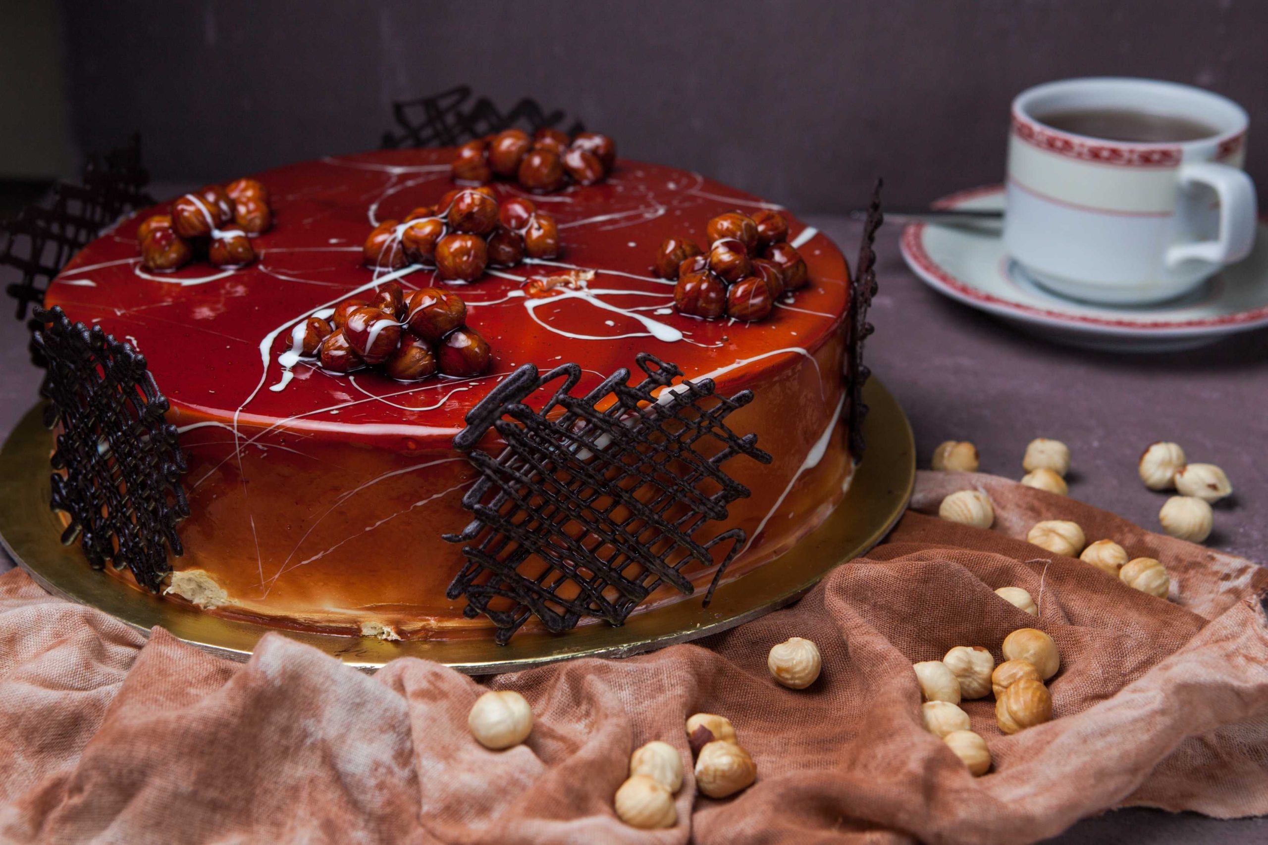 side-view-caramel-cake-with-nuts-cup-tea-rag (1)